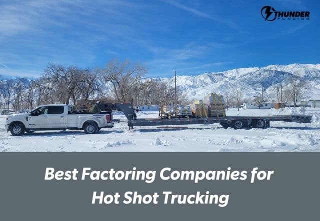 White pickup truck with gooseneck flatbed trailer loaded with freight, parked in a snowy mountain landscape — hot shot trucking owner-operator equipment.